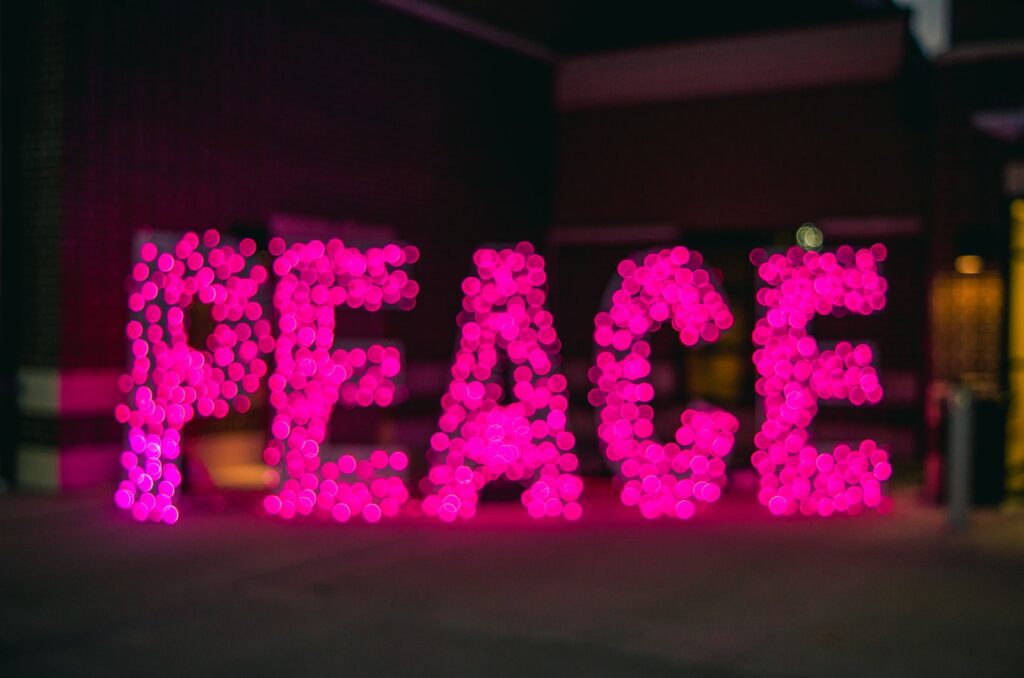 Peace wordings made by pink lights captured in a frame